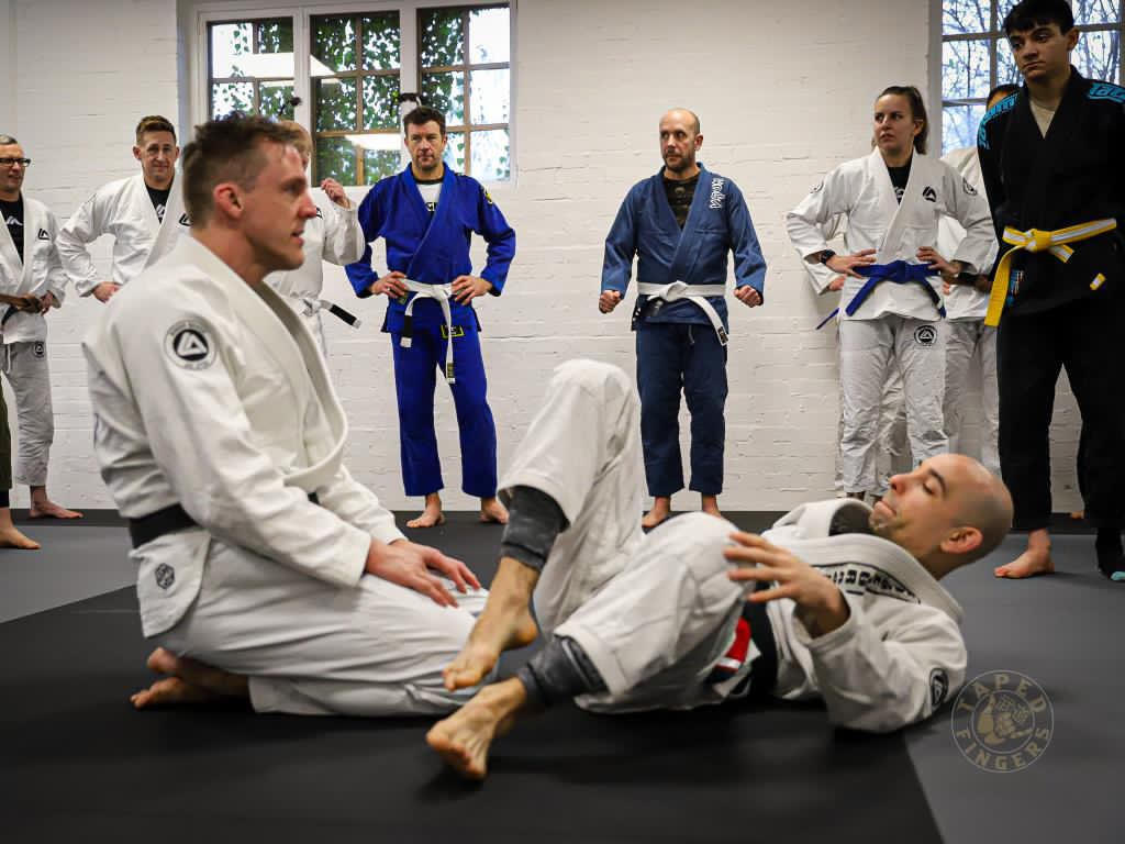 Adult students training together at RGA Buckingham, smiling and enjoying a friendly Jiu-Jitsu session on the mats.